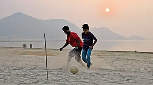 Passionate about sport: Children playing football on the banks of the Brahmaputra, Guwahati