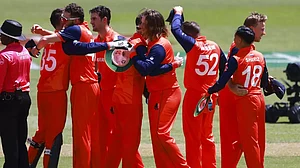 Netherlands players embrace and celebrate their upset win over South Africa.
