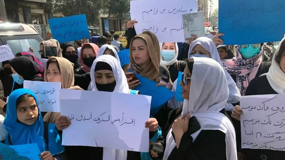 Afghan women chant and hold signs while staging a protest in Kabul