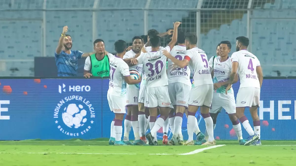 Odisha FC players celebrate a goal against East Bengal FC.