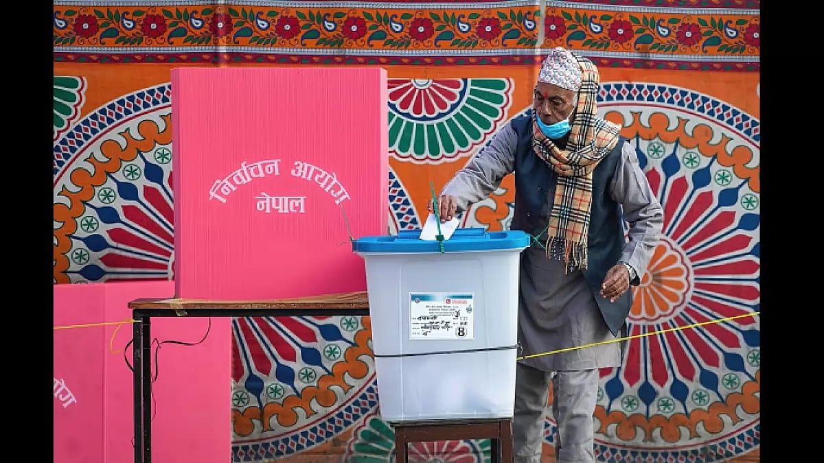 An old man casts his vote at a polling station in Kathmandu