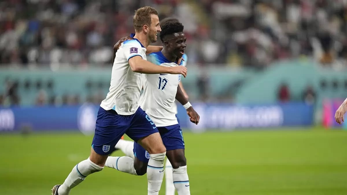 Bukayo Saka celebrates his goal with England captain Harry Kane.