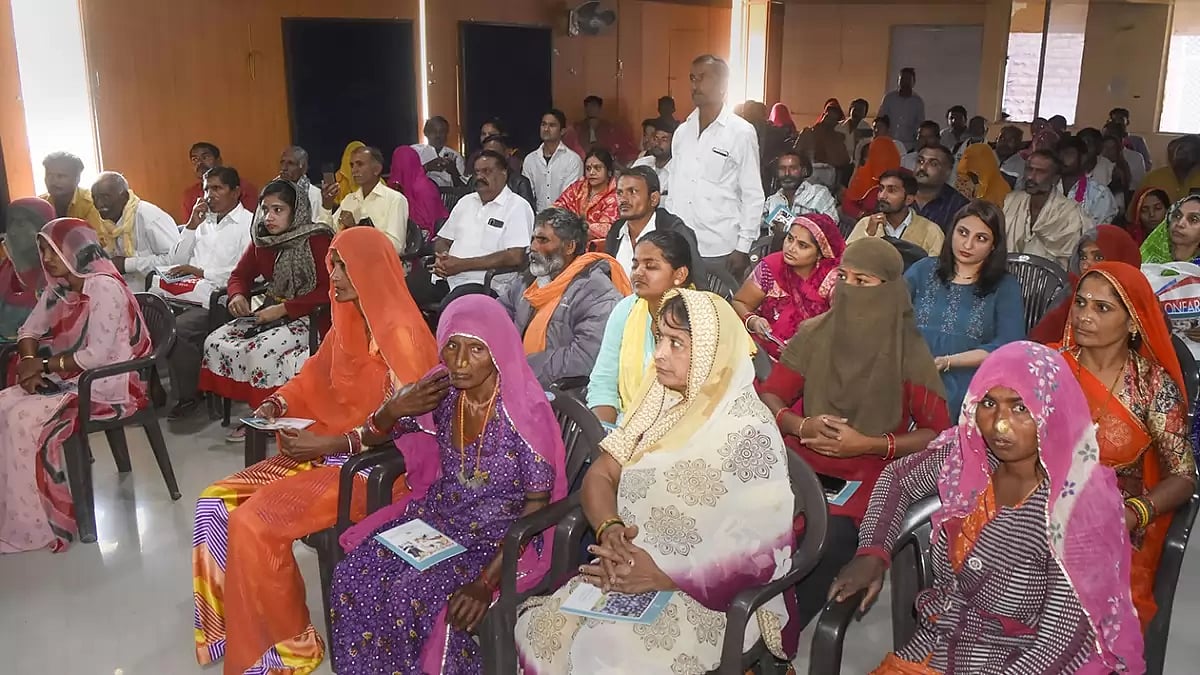 Pakistani refugees gather to receive their Indian citizenship certificates 