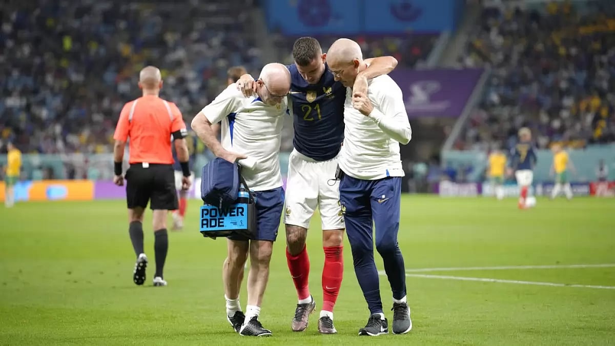 Lucas Hernandez is helped off the pitch after sustaining an injury against Australia.