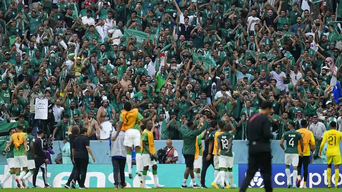 Saudi Arabia players acknowledge as their fans celebrate their win over Argentina.