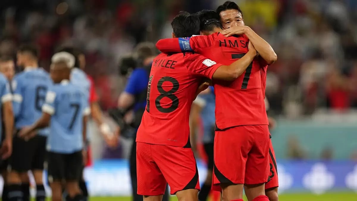 South Korea players hug after their hard-fought match against Uruguay.