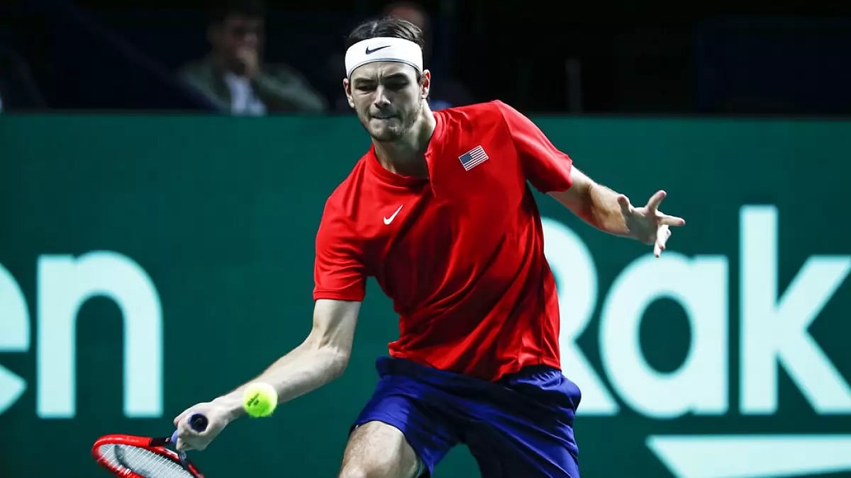 Taylor Fritz of USA returns a ball against Italy's Lorenzo Musetti.
