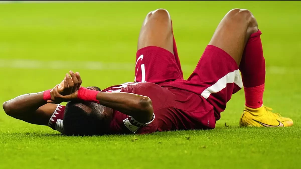 Qatar's Ismail Mohamad lies on the pitch dejected after his teams loss to Senegal.