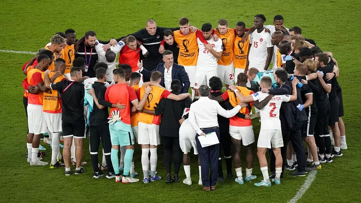 Canada's coach John Herdman interacts with his players after 1-0 loss to Belgium.