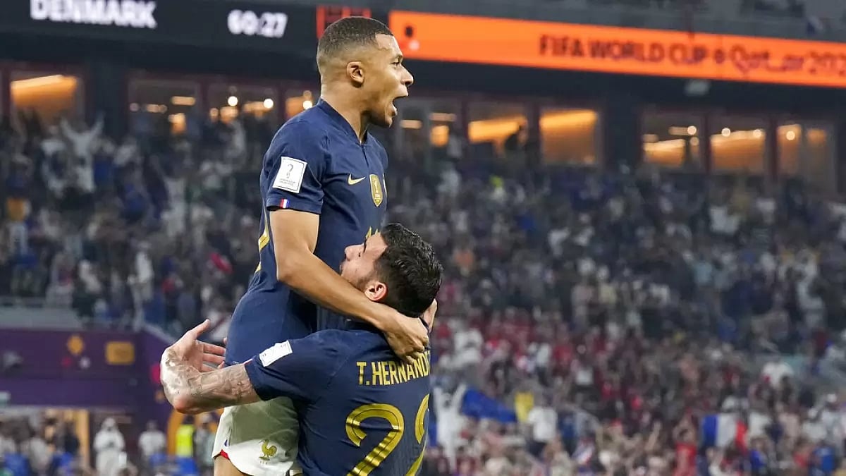Hernandez celebrates a goal with Mbappe against Denmark on Saturday.