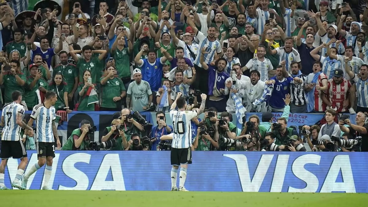 Messi poses for the cameras and fans after scoring a goal against Mexico.