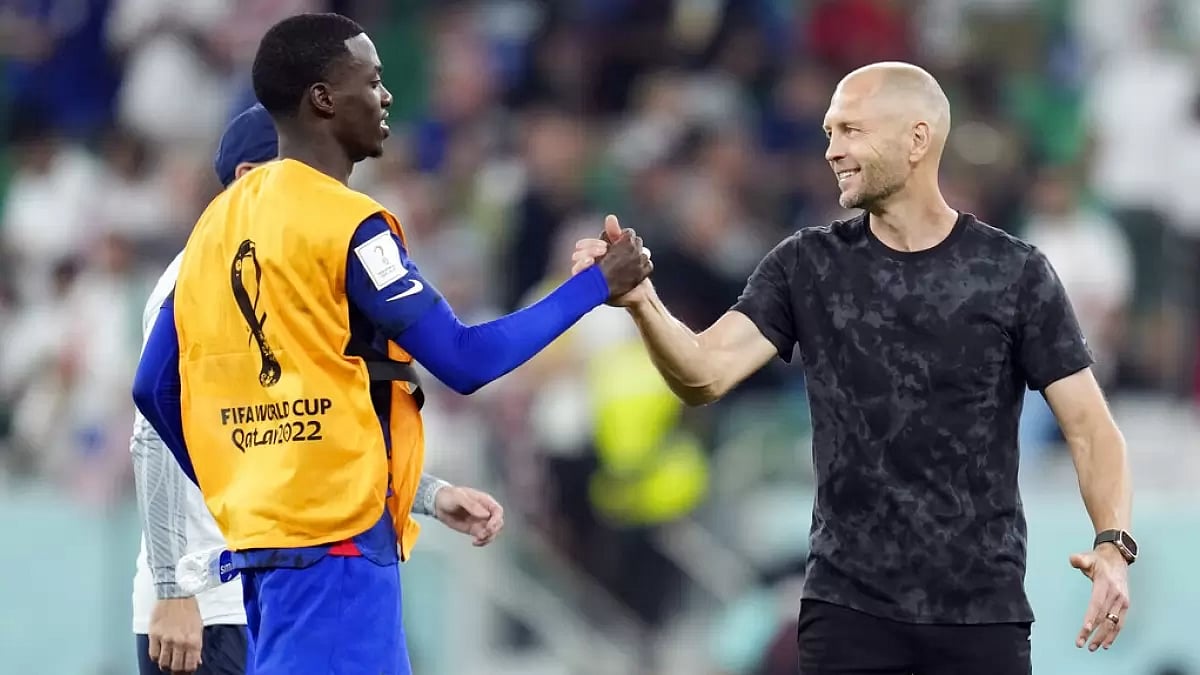 Berhalter celebrates with Tim Weah after his team's win against Iran on Tuesday.