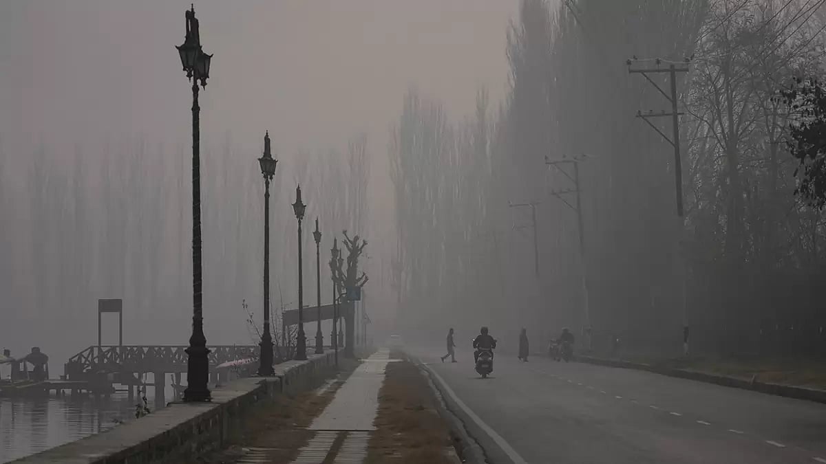 File photo: People walk on a cold and foggy morning in Srinagar,  Kashmir.