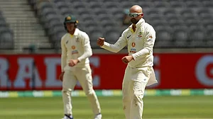 Nathan Lyon celebrates the wicket of Kemar Roach.