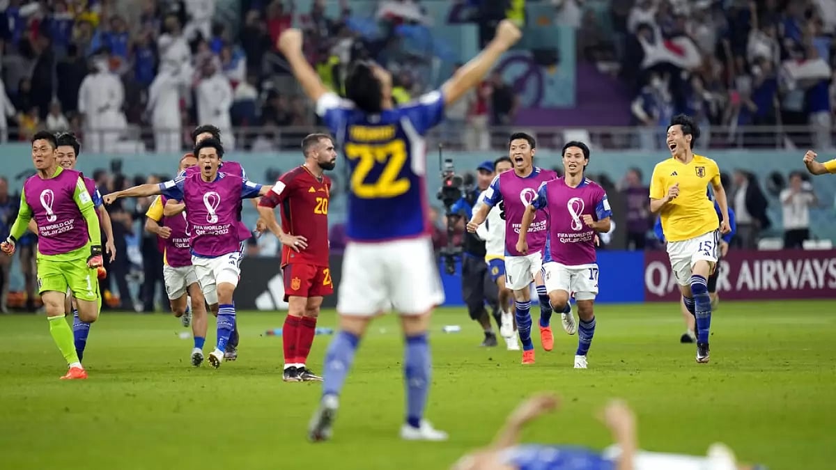 Japan players celebrate after their team's win against Spain in the group stage.