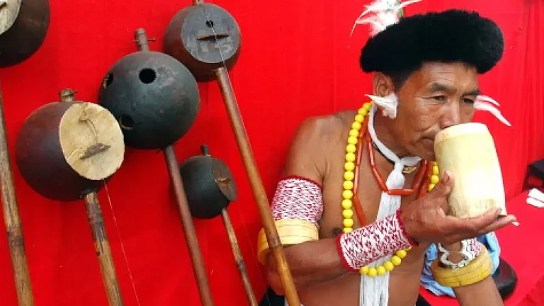 A man from the ethnic Angami community drinking from wooden glass at the Hornibill festival. - null