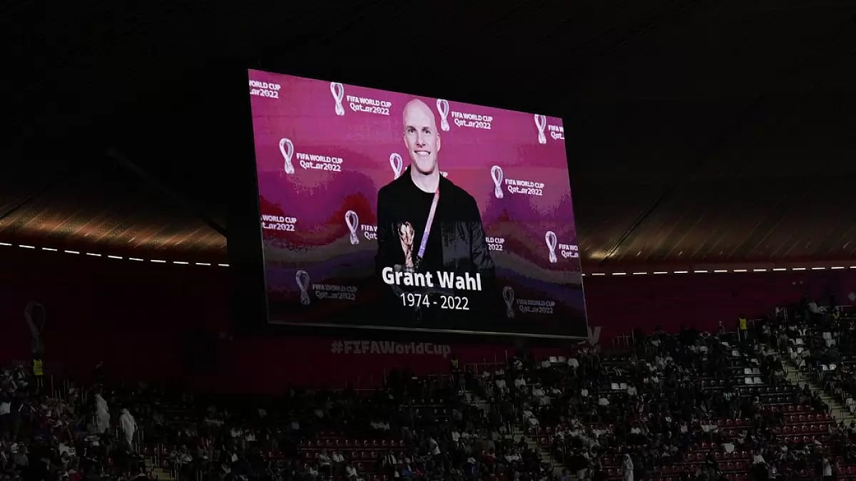 A tribute to journalist Grant Wahl is shown on a screen before ENG vs FRA on Saturday.