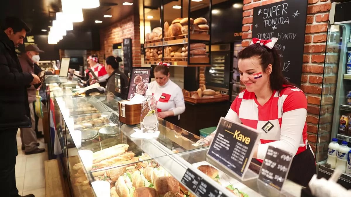 Bakery workers in Zagreb wear Croatia team kit to extend them their support in semifinal.