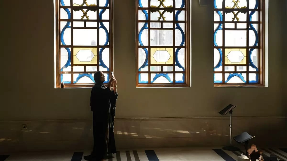 A Hungarian tourist takes pictures at Katara mosque in Doha, Qatar, Tuesday.