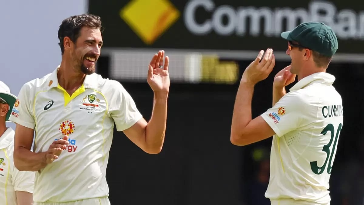 Mitchell Starc & Pat Cummins celebrate the wicket of Keshav Maharaj in the 1st Test on Sunday.