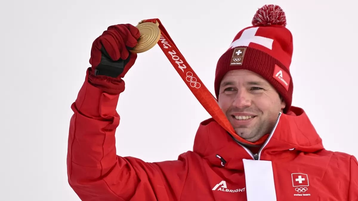 Feuz shows the Olympic gold medal that he won in Beijing in February.