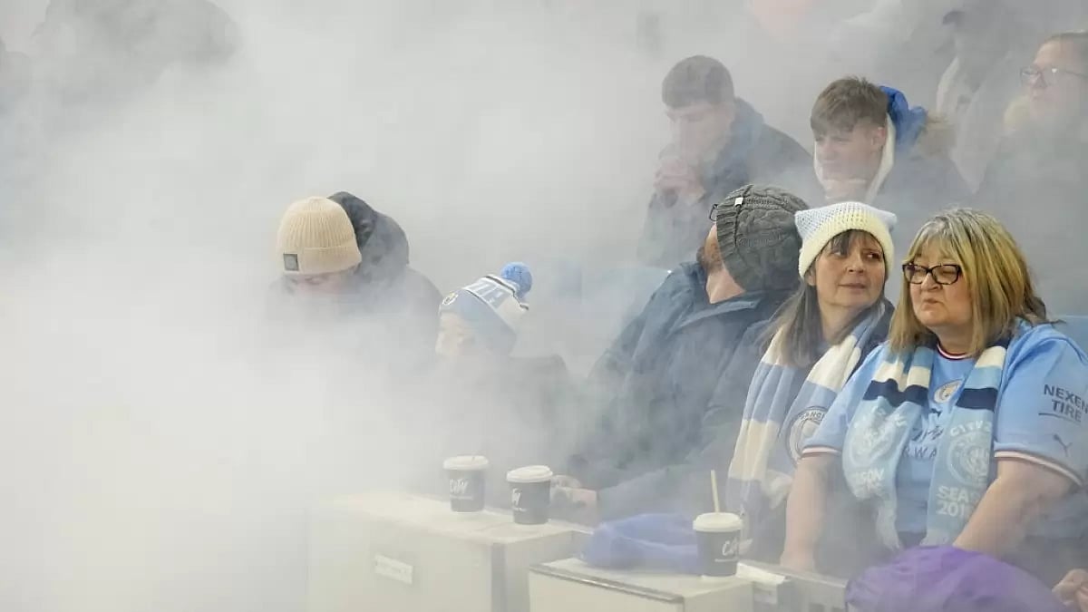 Smoke fills the stands after flares were lit at the Etihad Stadium.