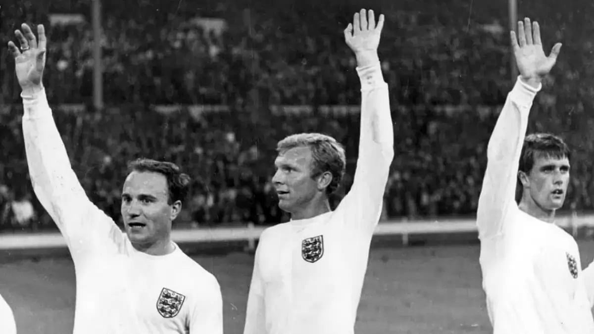 George Cohen, left, and captain Bobby Moore acknowledge the crowd at Wembley on July 29, 1966.