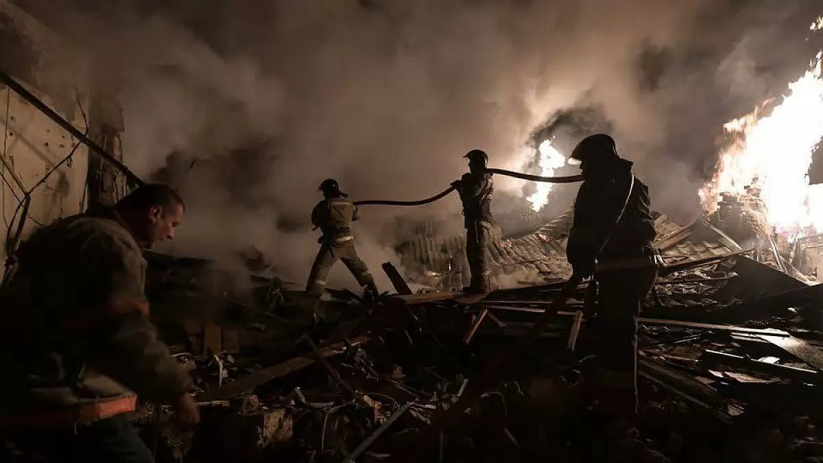 Firemen at work after an early morning blaze in a nursing home claimed at least 20 lives