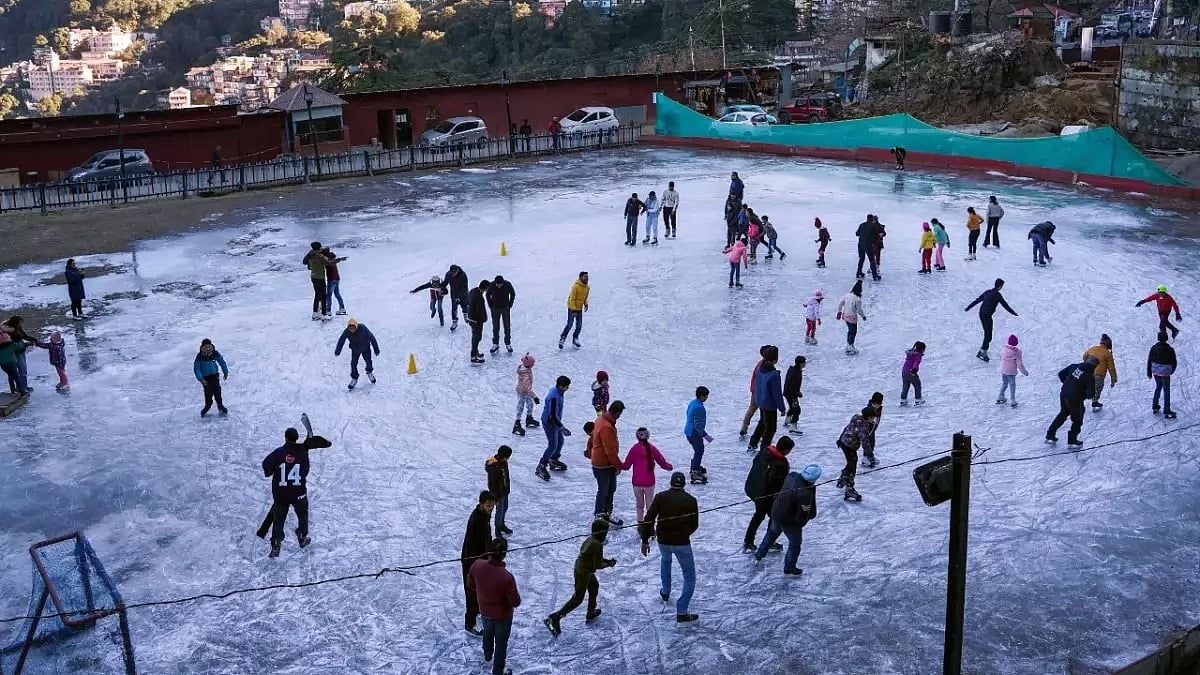 People skate at an ice skating rink, at Lakkar Bazar in Shimla