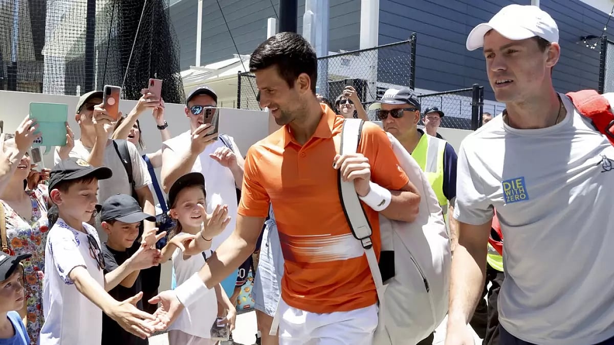 Djokovic, centre, with Pospisil for his doubles match at the Adelaide International on Monday.