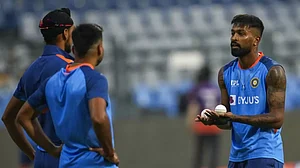 Hardik Pandya, right, interacts with team mates at a training session in Mumbai on Monday.