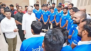 Naveen Patnaik, centre, interacts with players of the Indian hockey team in Rourkela.