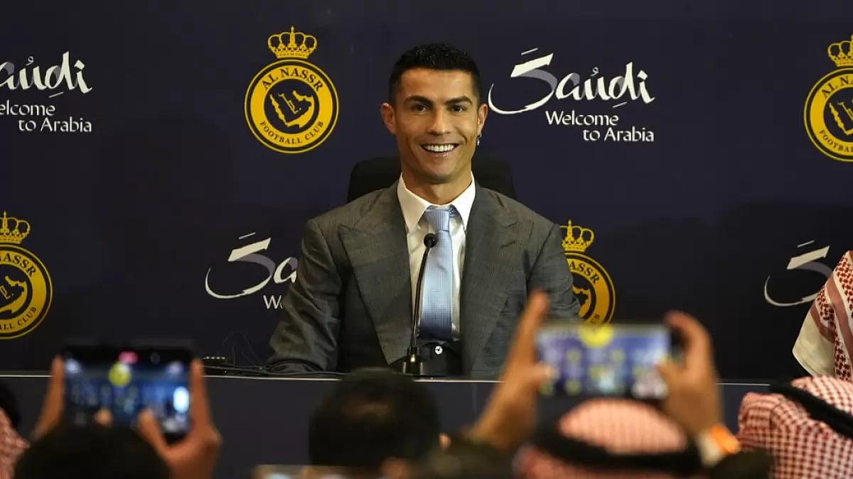 Ronaldo poses for the media during his official unveiling as Al Nassr's newest player.