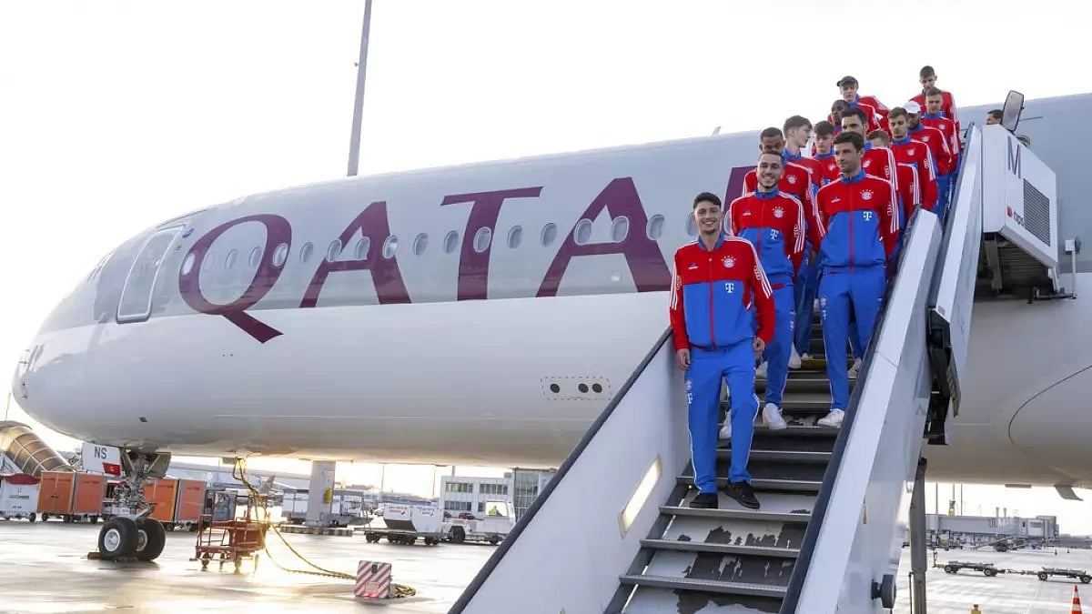 Bayern Munich players stand outside a Qatar Airways airplane in Munich on Friday.