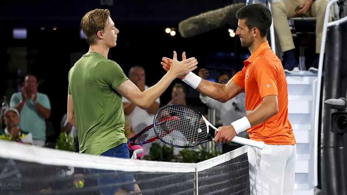 Djokovic, right, is congratulated by Shapovalov after his win in Adelaide International on Friday.