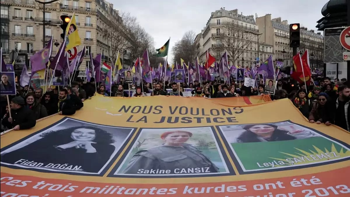 Kurdish activists holding a banner during a protest in Paris on Saturday. 