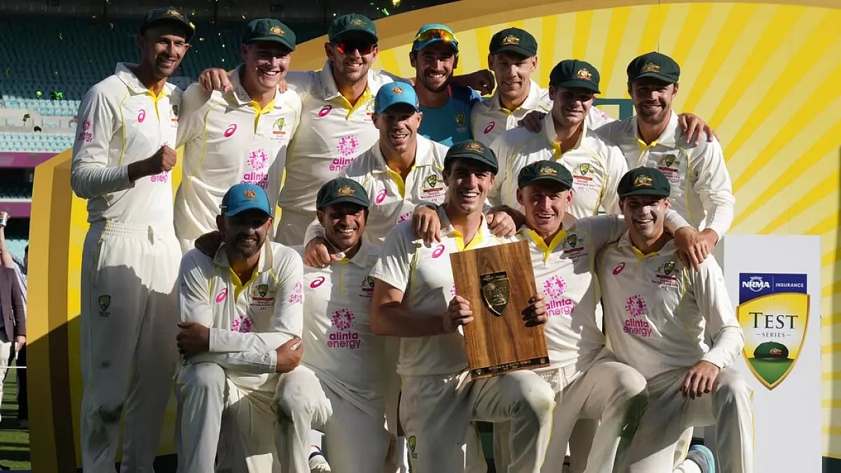 Australian players pose with the series trophy after the 3rd Test ended in a draw in Sydney on Sunday.