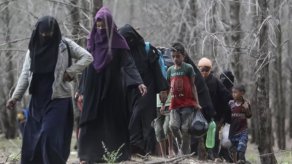 Ethnic Rohingya people walk to a temporary shelter after they landed in Aceh Besar, Indonesia.