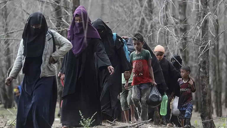 Ethnic Rohingya people walk to a temporary shelter after they landed in Aceh Besar, Indonesia. - null