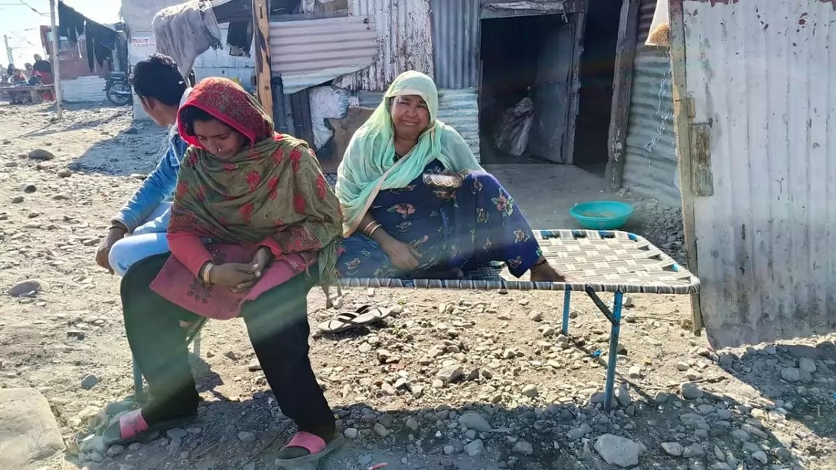 Concerned residents of Ghafoor Basti sit outside their homes in Banbhoolpura, Haldwani, Uttarakhand,