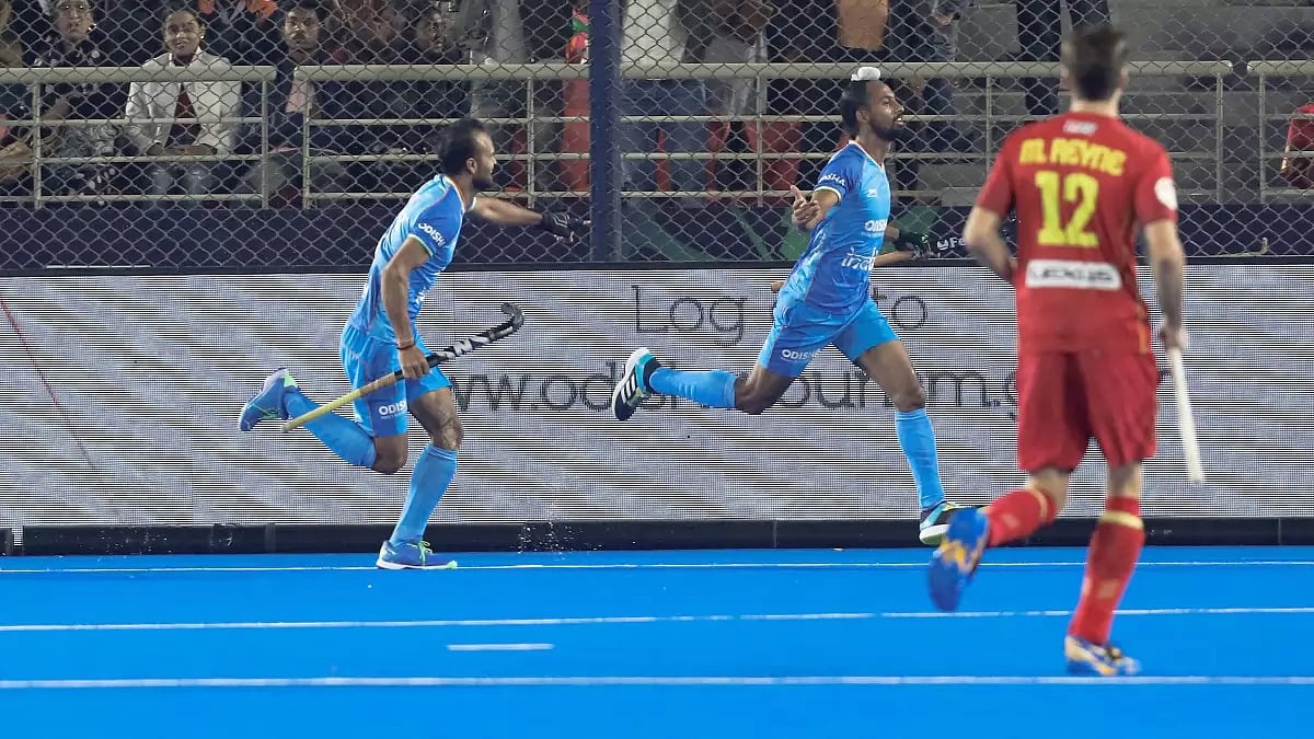 Hardik Singh, centre, celebrates after scoring India's second goal against Spain on Friday.