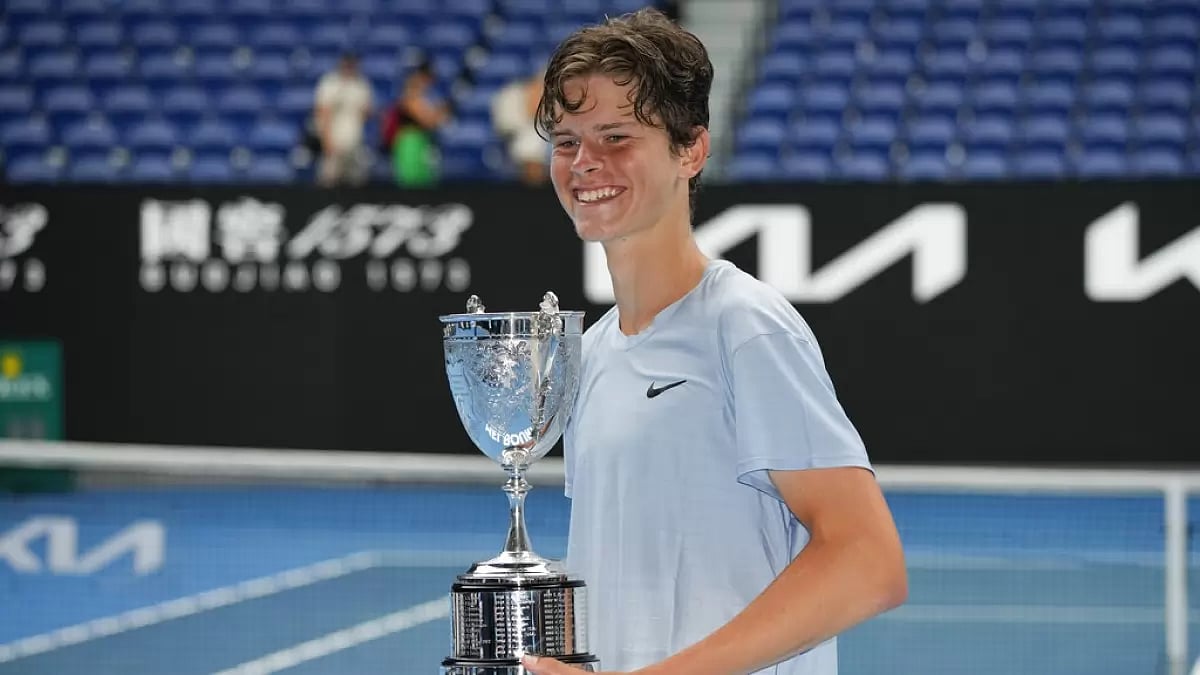 Alexander Blockx holds the juniors trophy after his finals win on Saturday.