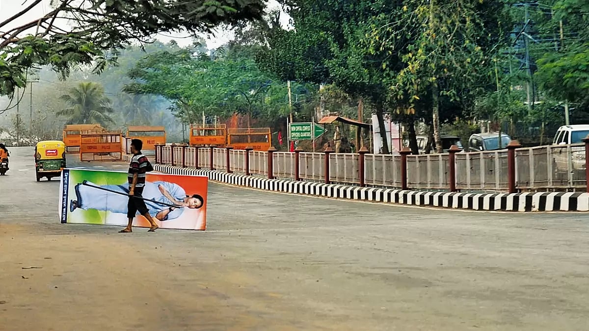 Knocking at Their Doors: A TMC worker carries Mamata Banerjee’s poster during the 2018 Tripura elect
