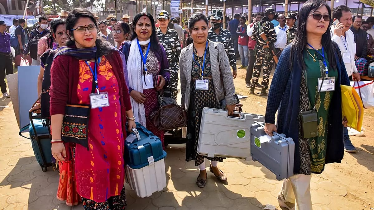 Women poll officials head towards their respective polling stations for the Tripura Assembly elections, in Agartala.