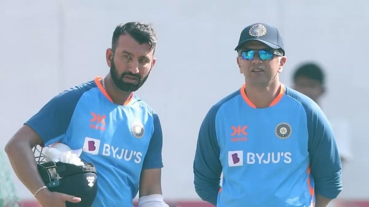 Pujara, left, speaks with coach Rahul Dravid during a team training session on Thursday.
