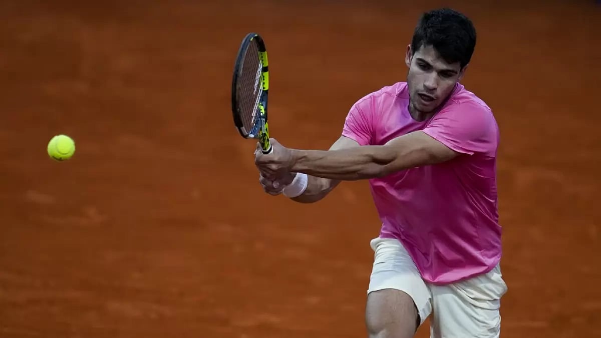 Alcaraz returns a backhand shot against Miralles on Saturday.