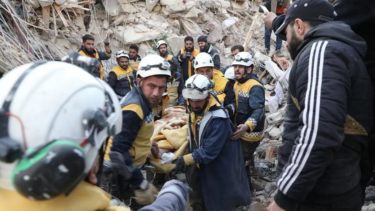 White Helmets personnel rescuing trapped people in earthquake-hit Syria