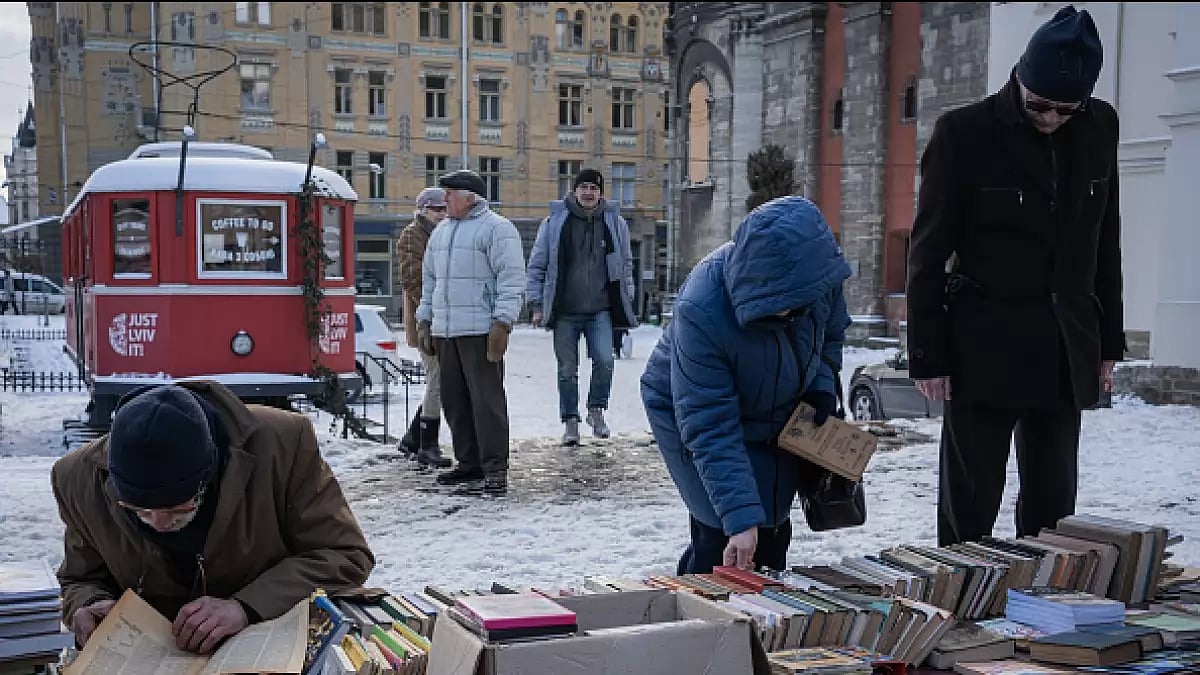 Salesmen sell books at the city square as citizens carry on with their daily lives in Lviv, which is one of the safest cities since the beginning of the war between Russia and Ukraine despite the occasional sirens and possible attacks in Ukraine on February 17, 2023.