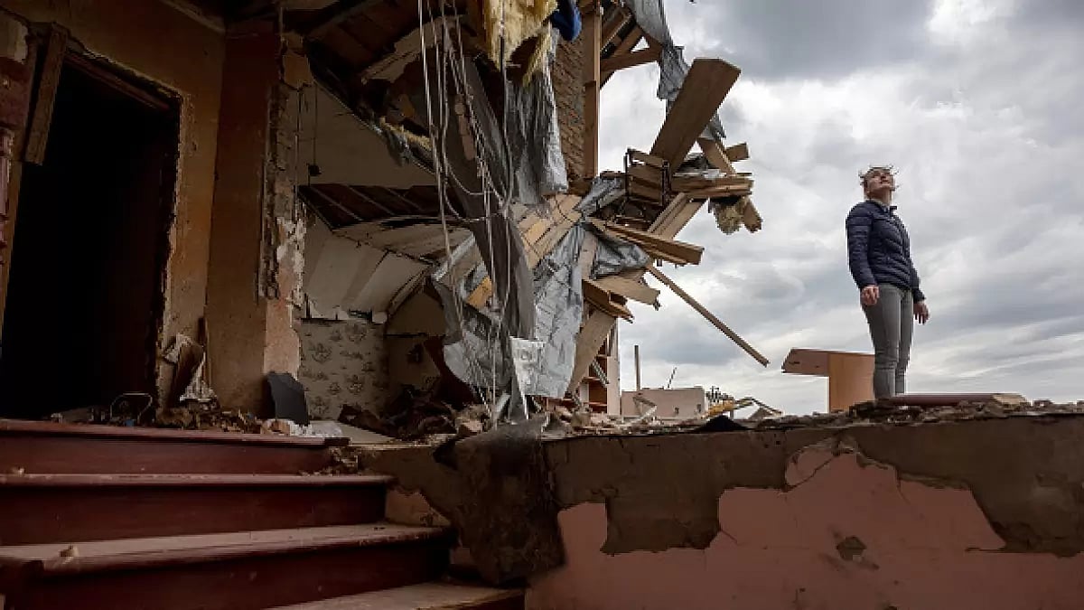 HOSTOMEL, UKRAINE - Oksana surveys the destroyed second floor of her multi-generational home