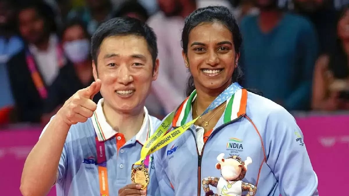 Sindhu celebrates her gold medal at the 2022 Commonwealth Games with coach Park Tae Sang.